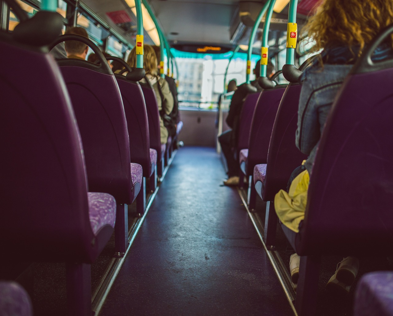 A photo of the top deck of a First Bus. The seats have purple upholstery.