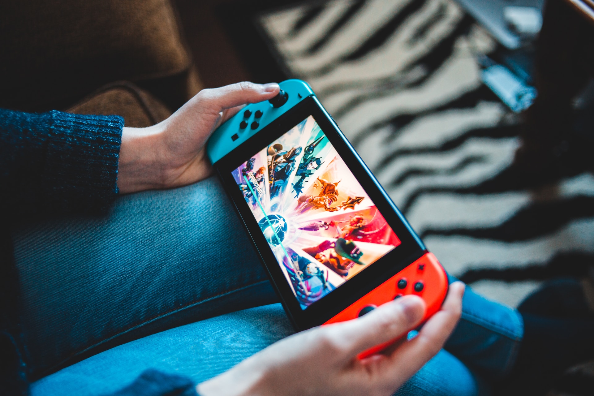 A photo of someone holding a Nintendo Switch console
