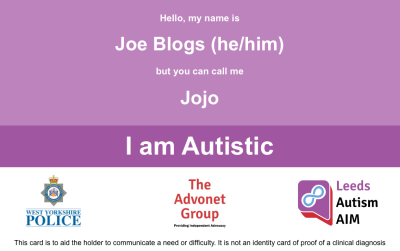 The front of our autism alert card. It has a name, pronouns, and the words 'I am autistic' in the middle. Below that, there are the West Yorkshire Police, Advonet Group and Leeds Autism AIM logos.