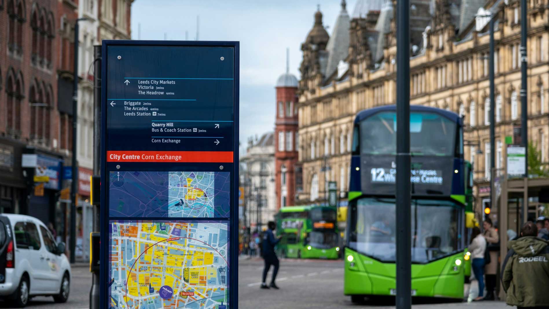 An image of a number 12 bus in Leeds City Centre. On the left-hand side of the image, there is a map of the city centre.